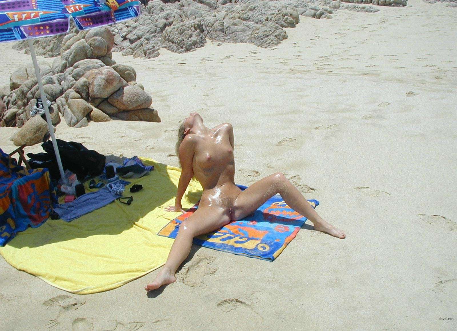 Nude Woman Sunbathing on Beach - Explicit Amateur Porn Photo