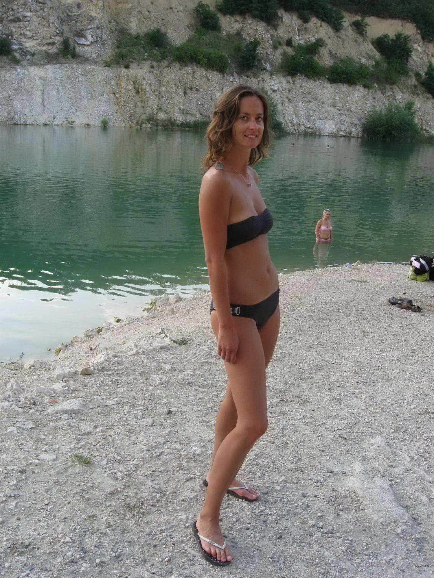 Topless Woman Poses Boldly on Vacation Beach