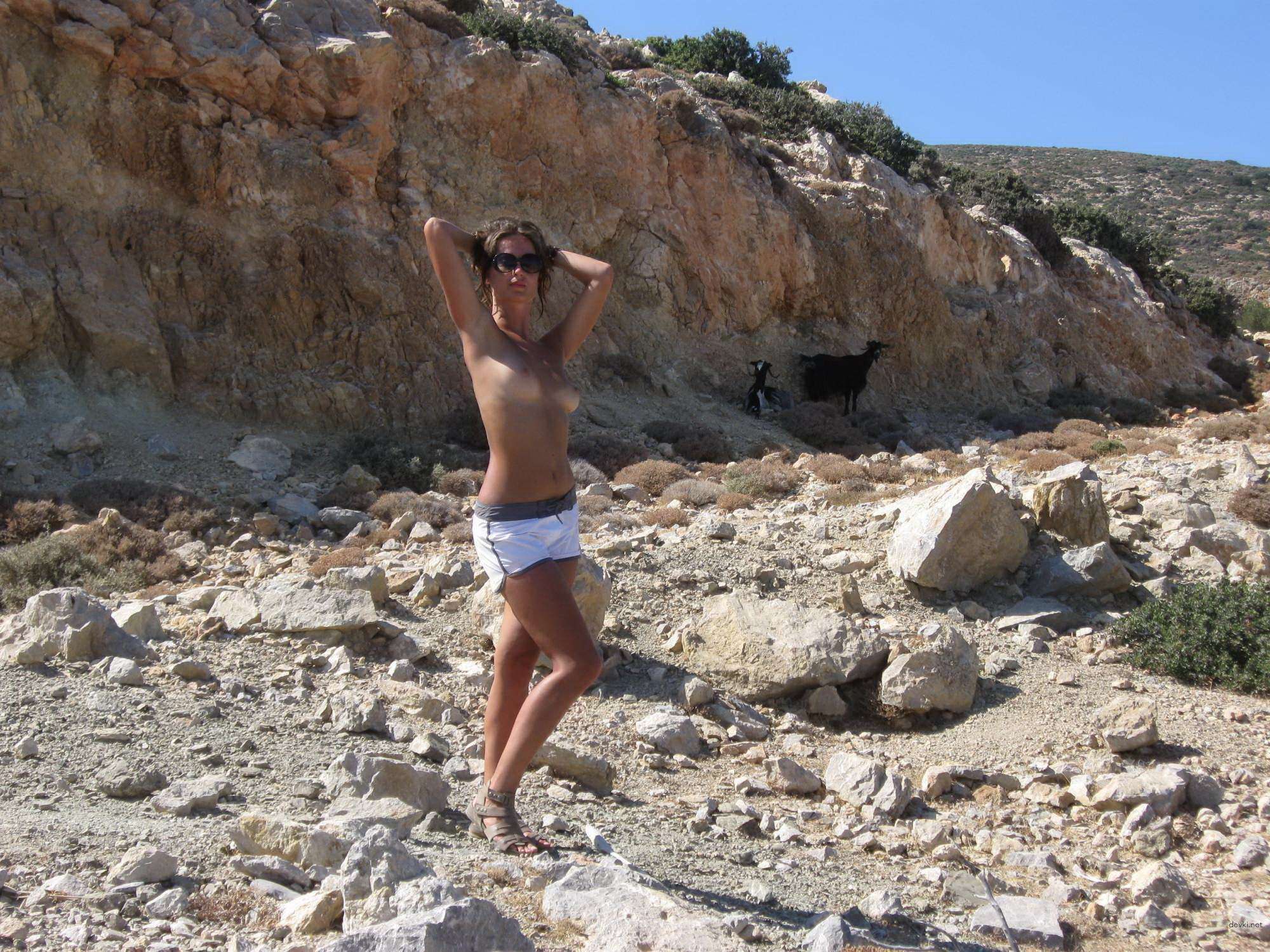 Topless Woman Poses Boldly on Vacation Beach