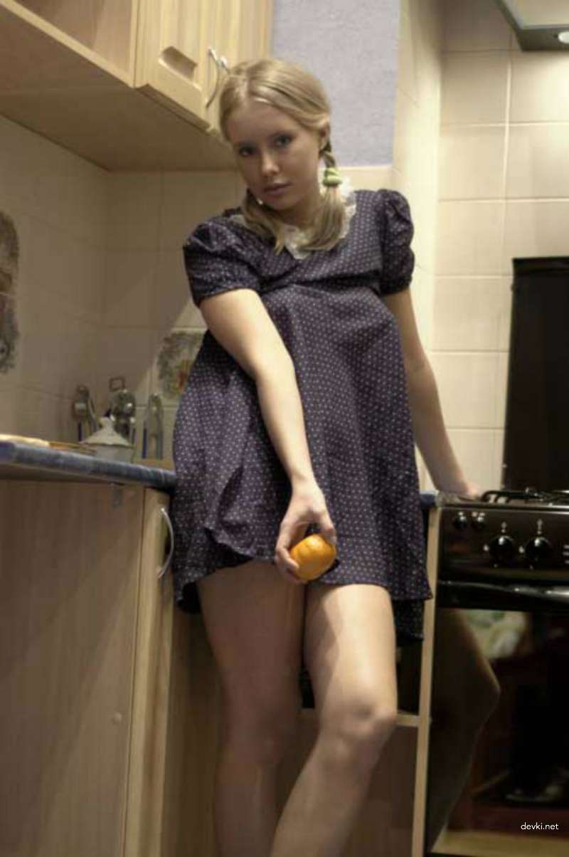 Seductively lifting her dress in the kitchen - Amateur photo explicit content