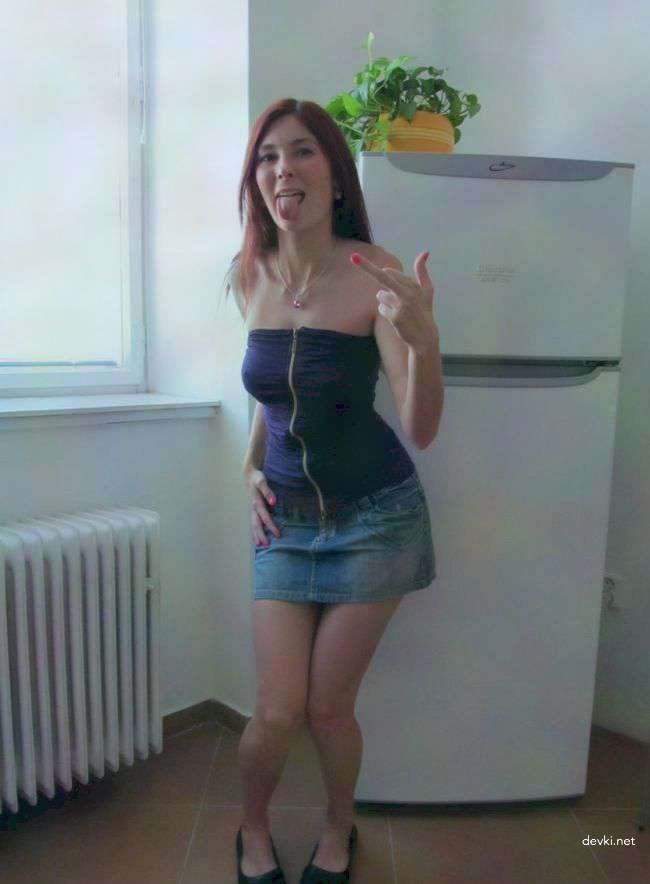 Amateur Girl's Explicit Photoshoot by the Fridge: Seductive Poses and Revealing Outfits