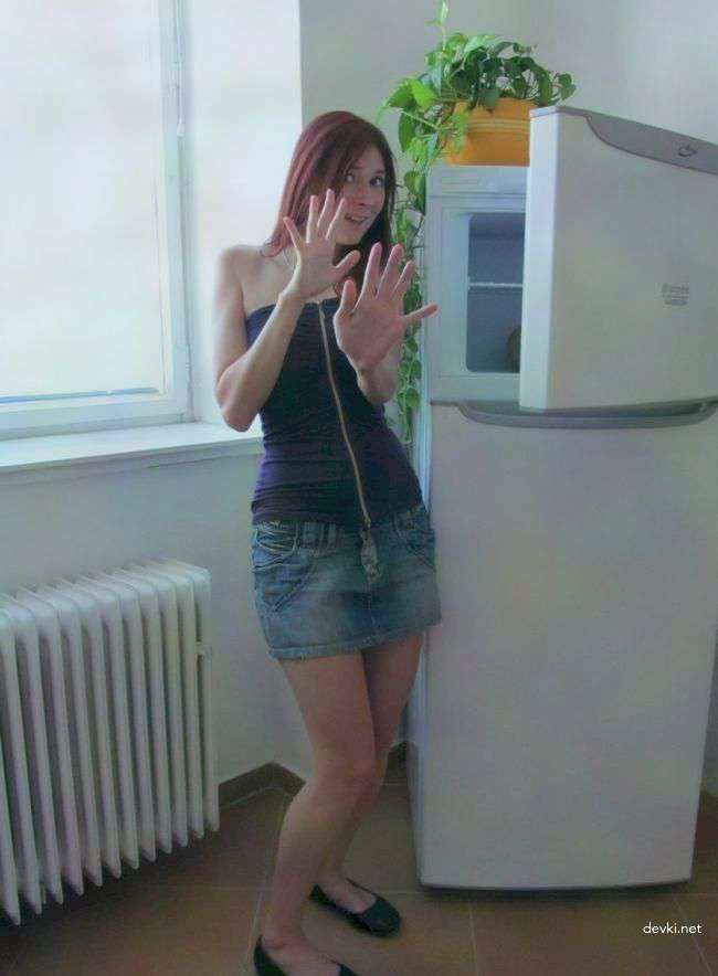 Amateur Girl's Explicit Photoshoot by the Fridge: Seductive Poses and Revealing Outfits