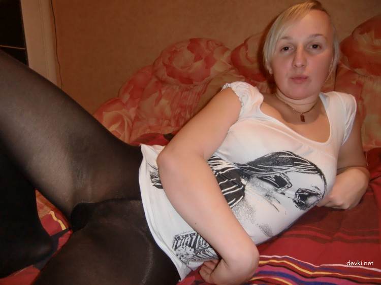 Wife posing on bed in black pantyhose without panties - Amateur explicit photo