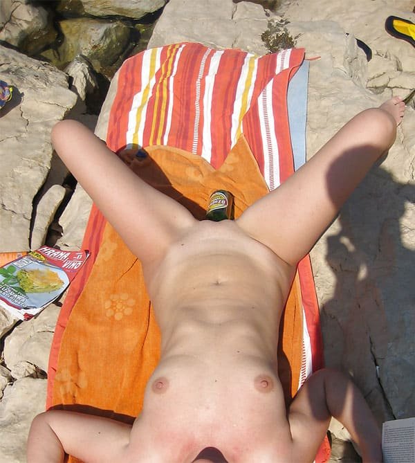 Beach Nudist Masturbates with Bottle - Explicit Amateur Porn Photo